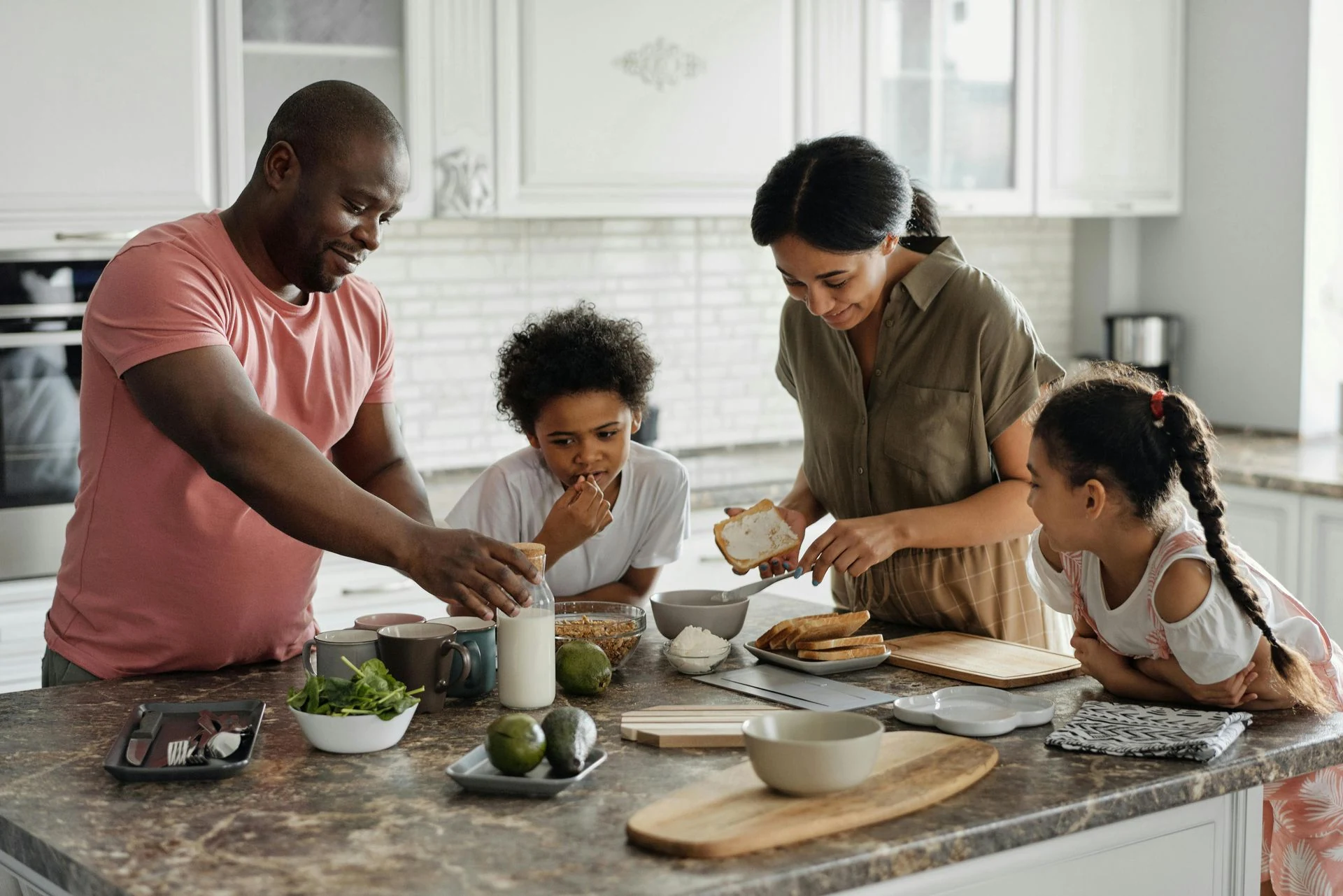 Family making food together in a kitchen.